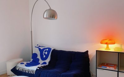 a living room with a couch and a lamp